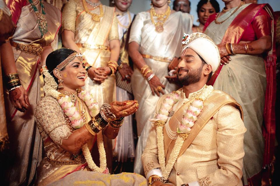 A pose capturing the couple as they share a loving look, possibly during the wedding rituals, highlighting their emotional bond.